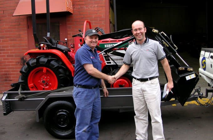 A satisfied customer with a remanufactured Kubota tractor.