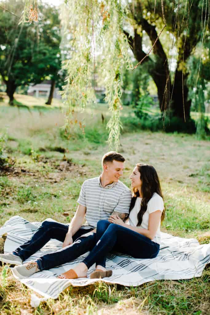 couple sitting golden hour engagement pictures