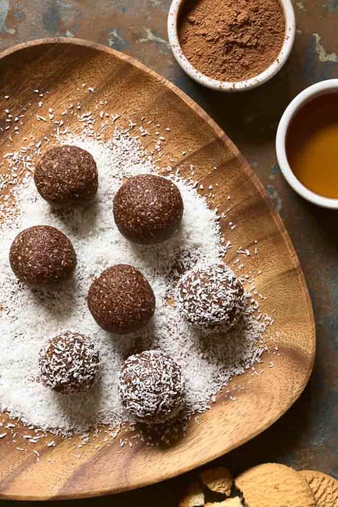 Coconut Rum Balls Coconut rum balls being rolled and coated in coconut