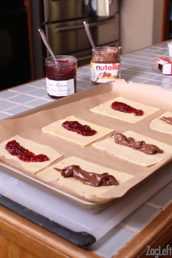 Spooning the filling of jam and nutella onto the dough