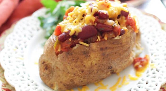 Chili Cheese Baked Potato shown on a white plate