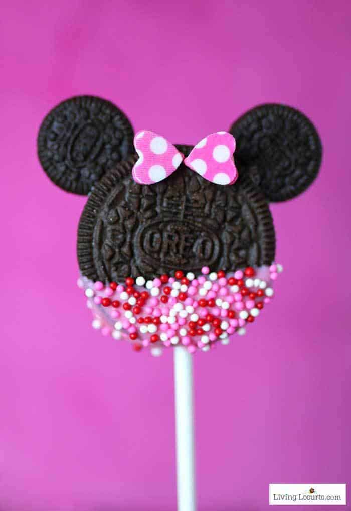 An Oreo cookie on a stick shaped and decorated to resemble Minnie Mouse