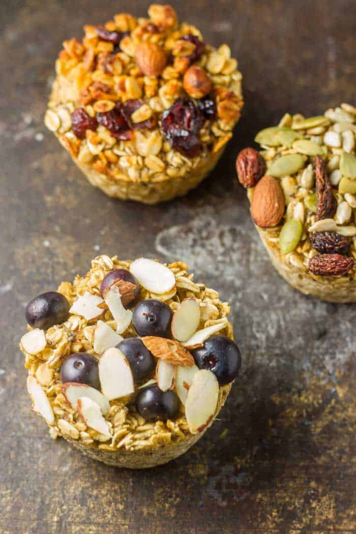 Baked Oatmeal Cups - Superfood Style Baked Oatmeal Cups in muffin tin just out of the oven on a black plate.