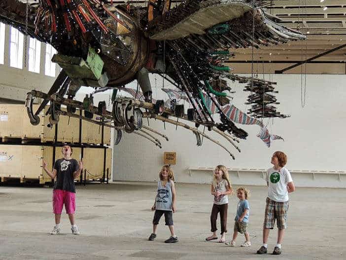 Best Museums in the Berkshires of Massachusetts Several kids stand under a giant art installation at MASS MoCA in the Berkshires.