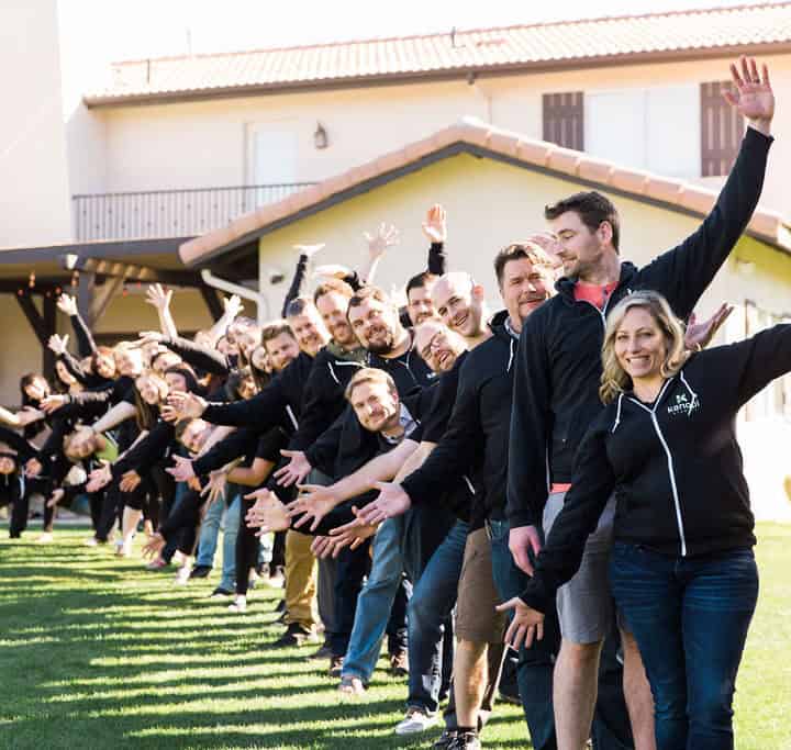 Image of all Kanopi staff in a line retreating in the distance, and everyone has their arms outstretched. CEO Anne Stefanyk is in front.