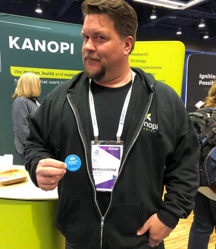 Drupal developer Jim Birch with his Acquia certification badge at DrupalCon