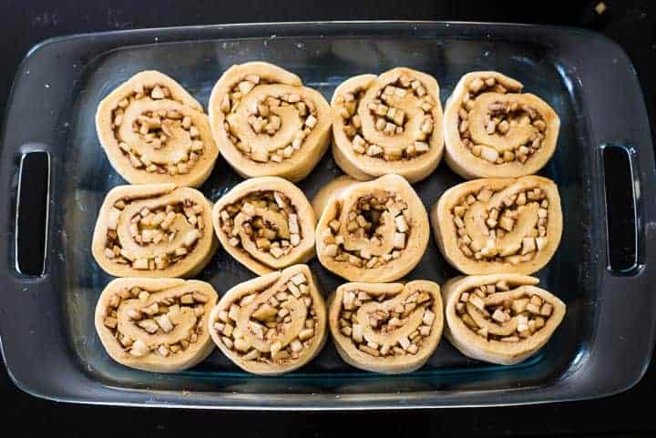 Apple cinnamon rolls assembled and in the baking pan before the second rise.