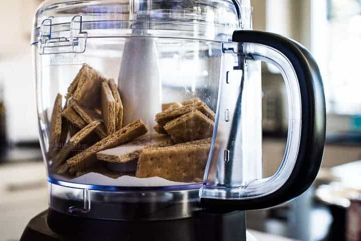 Making a graham cracker crust: graham crackers and sugar in the food processor.