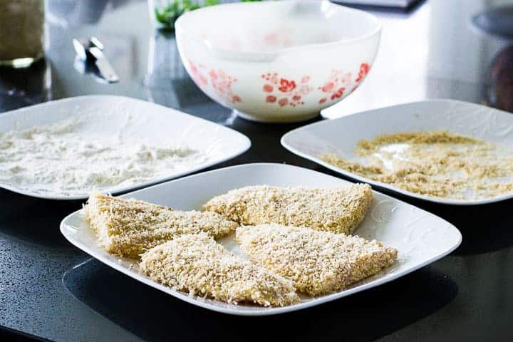 Four pieces of panko crusted rockfish at the dredging station waiting to be fried.