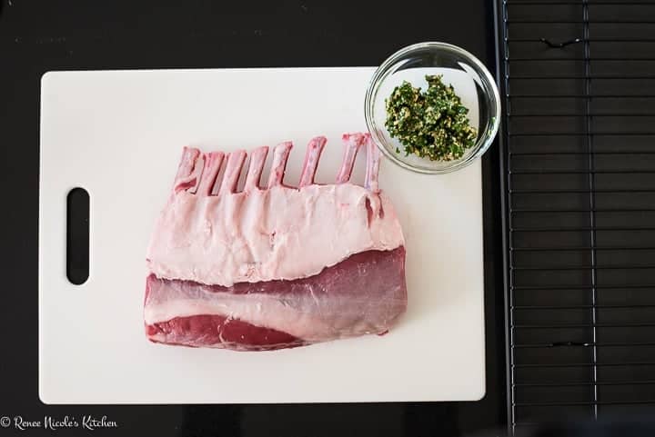 Prep shot for fennel garlic roast rack of lamb. A French trimmed rack of lamb next to the fennel garlic rub.