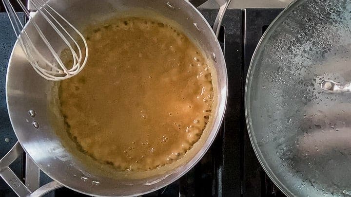 Overhead shot of guinness gravy cooking on the stovetop.