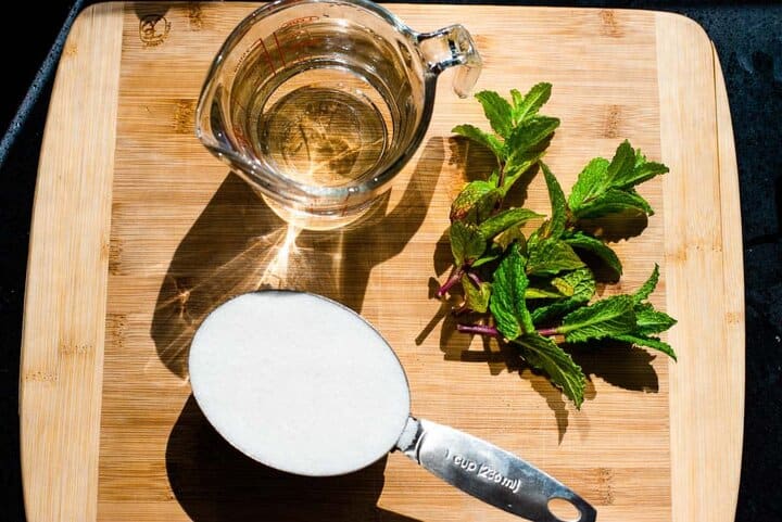 The ingredients for mint simple syrup: mint, sugar, and water.