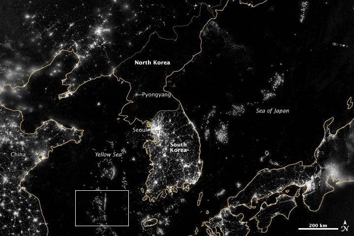 An updated higher resolution image (September 24, 2012) captured by the the Visible Infrared Imaging Radiometer Suite (VIIRS) on the Suomi NPP satellite shows in more detail the darkness of North Korea at night. More about the Map of the Earth's Night Light.