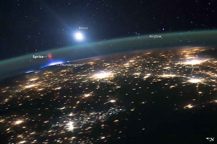 Astronauts aboard the International Space Station captured this view of a red sprite above the white light of an active thunderstorm high above Missouri or Illinois. Image: NASA, August 10, 2015.