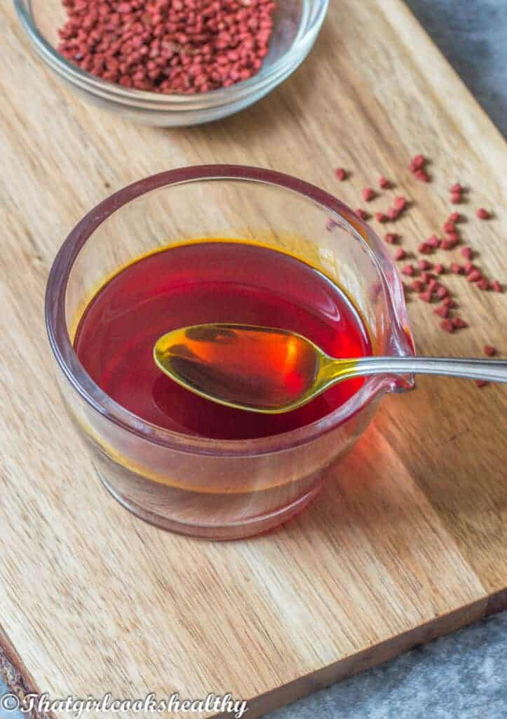 spoon scooping up the oil