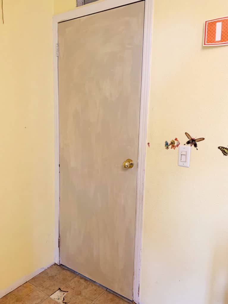 light brown door in yellow room