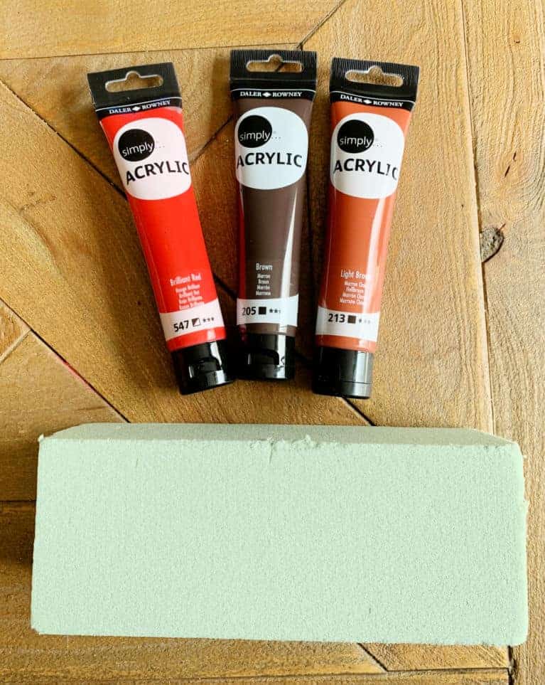 red colored paints and green foam rectangle