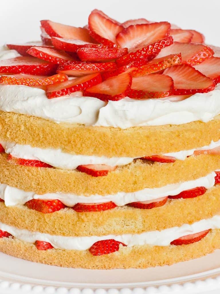 strawberry cake with sponge cake, whipped cream frosting and fresh strawberries