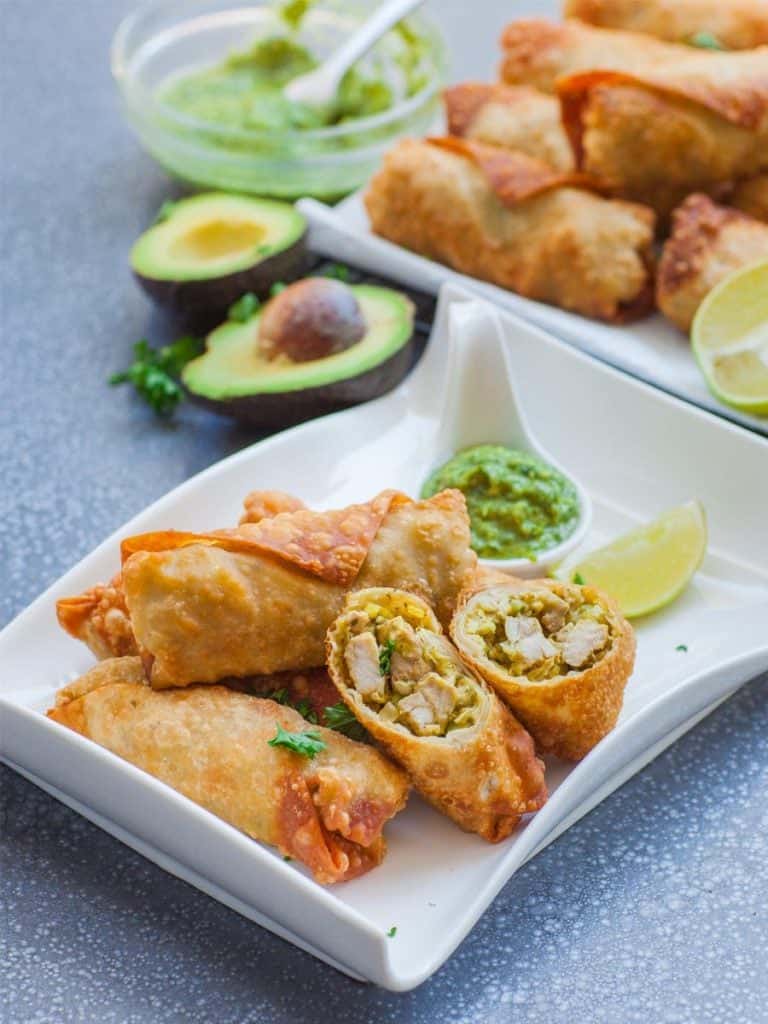 avocado chicken egg rolls with chimichurri sauce and lime wedge