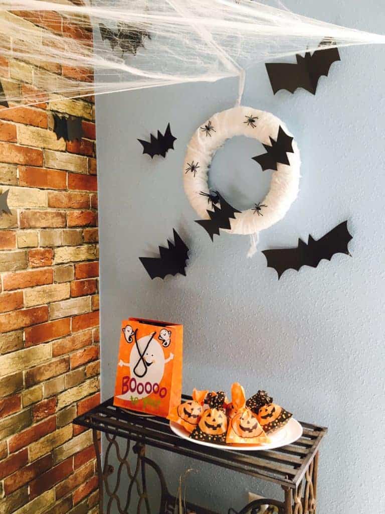 wreath with paper bats hung up on a wall