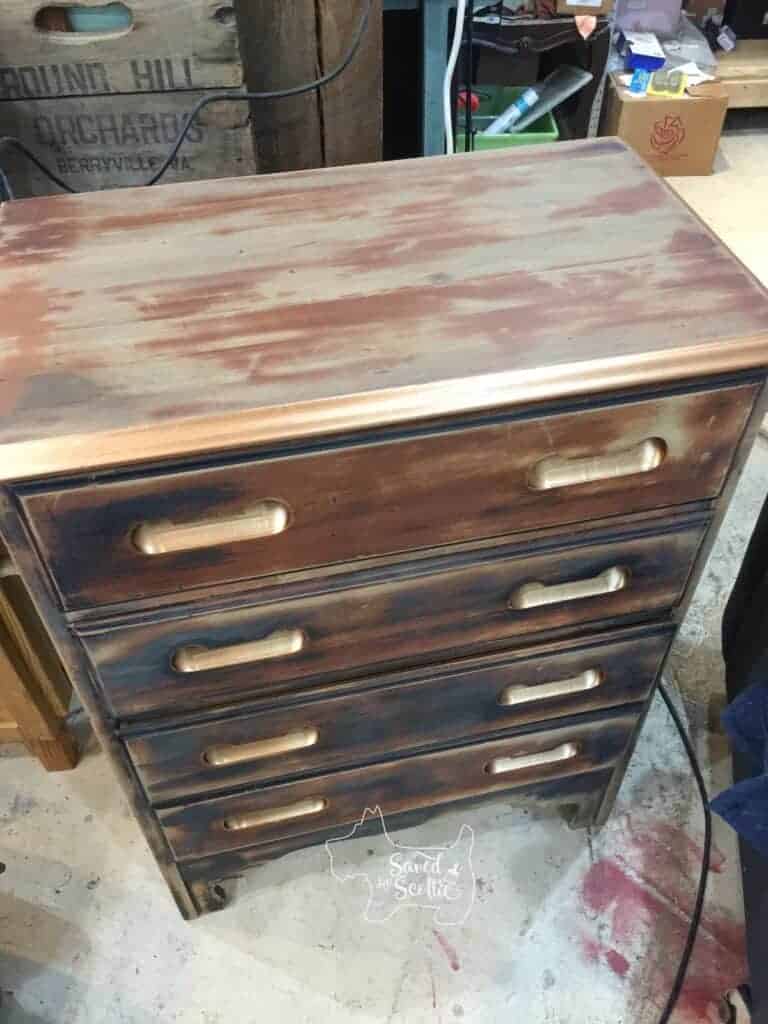 picture of dresser from the top tangle o show the entire piece and the copper painted touches are shining and showing up as metallic.