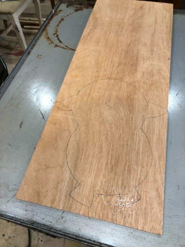 silhouette of sheep traced out on piece of plywood ready to be cut out for the BFF gift