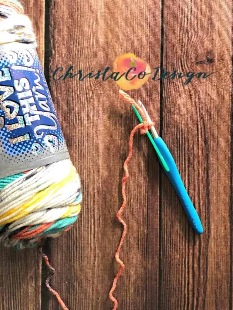 picture of yarn, hook and needle for triangle scarf