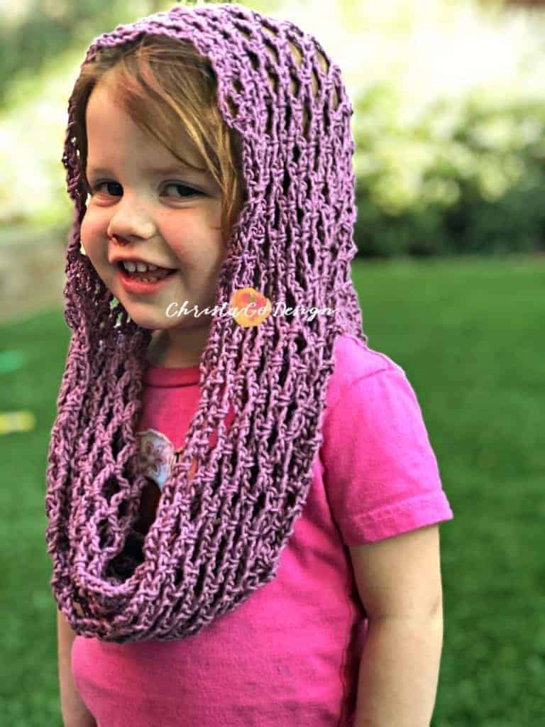 picture of toddler smiling with crochet cotton cowl draped on head