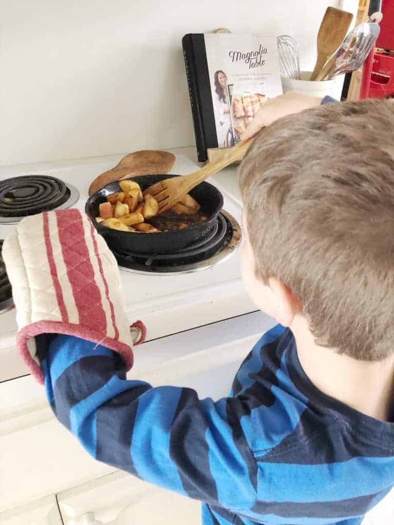 child stirring apples