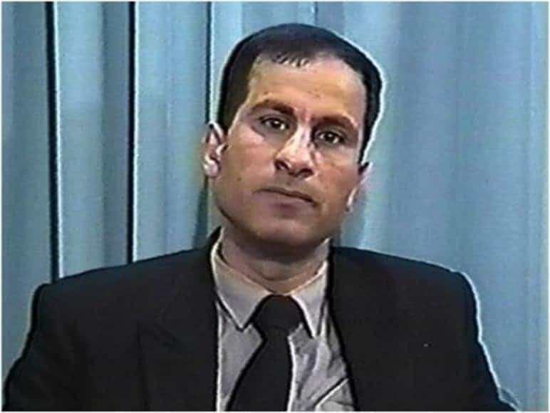 Ali Mohamed against blue background