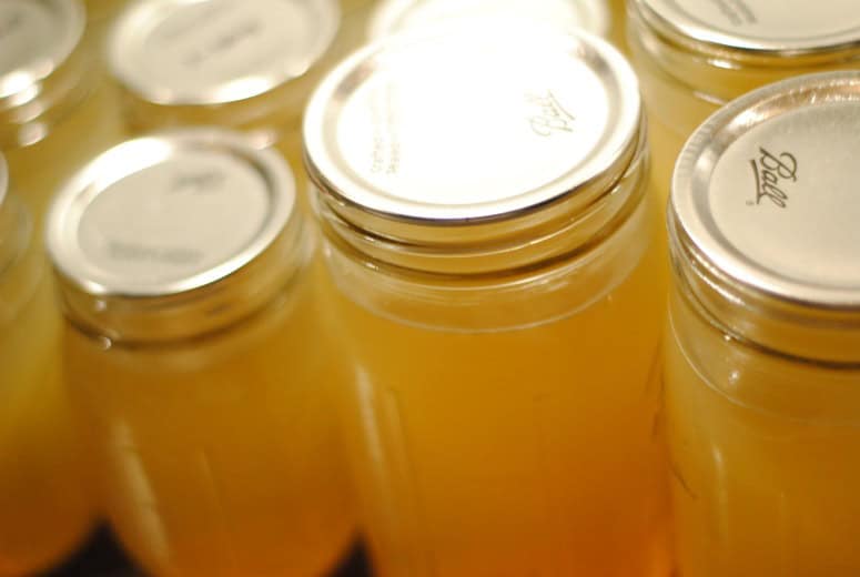 Close up shot of jars of golden bone broth.