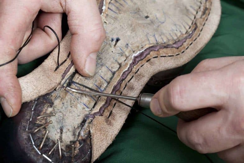 When hand welting a holdfast is cut out of the insole (except in Italy, where shoemakers usually do the stitching to the flat sole by digging the awl down and up) which the welt seams is stitched to, connecting uppers and welt. Picture: Claymoor's List