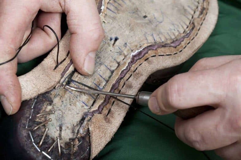 When hand welting a holdfast is cut out of the insole (except in Italy, where shoemakers usually do the stitching to the flat sole by digging the awl down and up) which the welt seams is stitched to, connecting uppers and welt. Picture: Claymoor's List