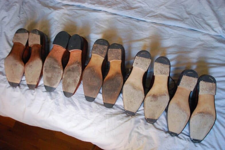 Five pairs with flush rubber toe taps. The three pairs to the left have had them installed in the workshop, the other's are attached by a cobbler.