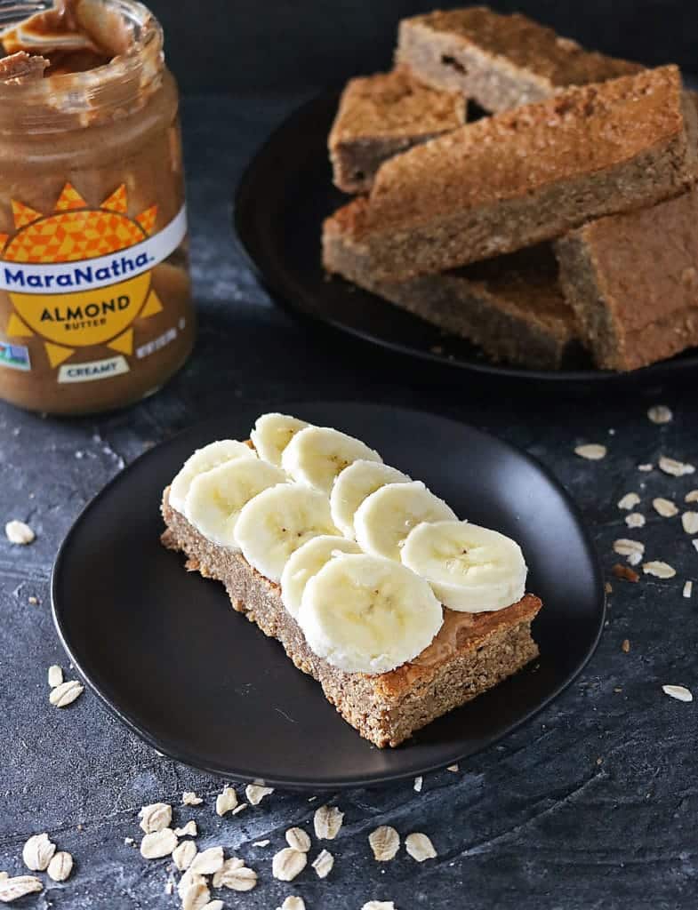 Gluten Free Almond Date Bars slathered with MaraNatha Almond Butter and topped with sliced banana