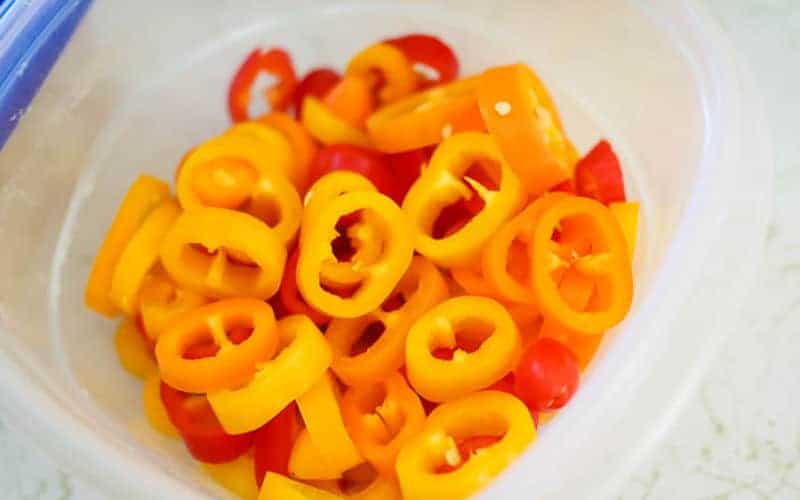 slicked sweet peppers in a container