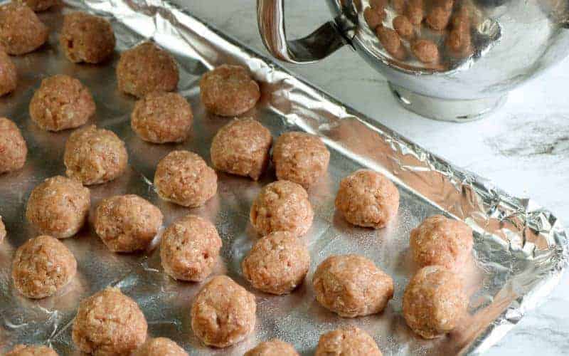 oven baked turkey meatballs on a aluminum foil lined baking sheet