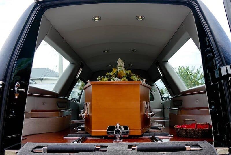 closeup shot of a colorful casket in a hearse or chapel before funeral or burial at cemetery