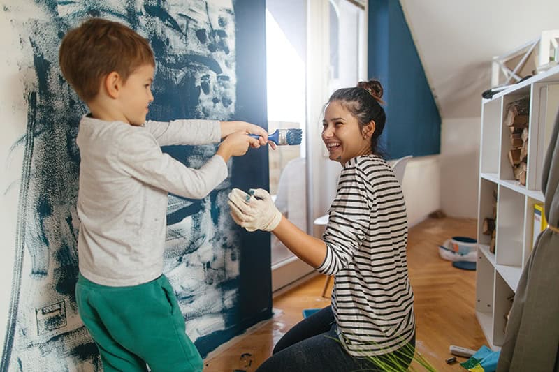 Mother and son painting walls