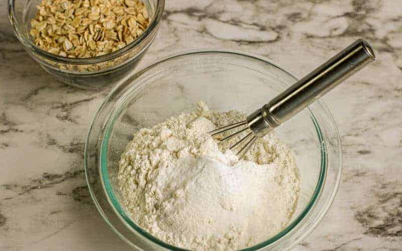 mixing dry ingredients for peanut butter choc chip oatmeal raisin all star cookies