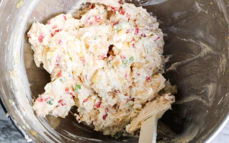 stirring the ingredients for a pineapple cheese ball