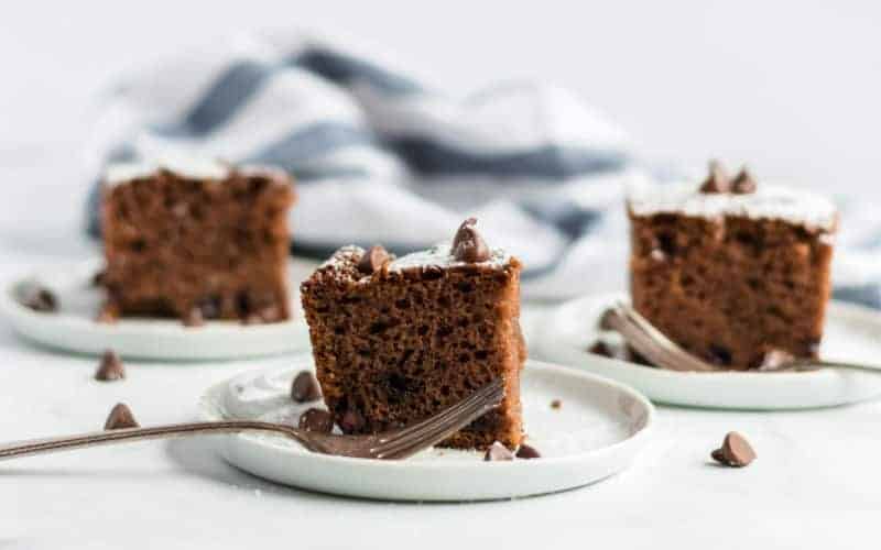 three pieces of chocolate chip cake on white plates