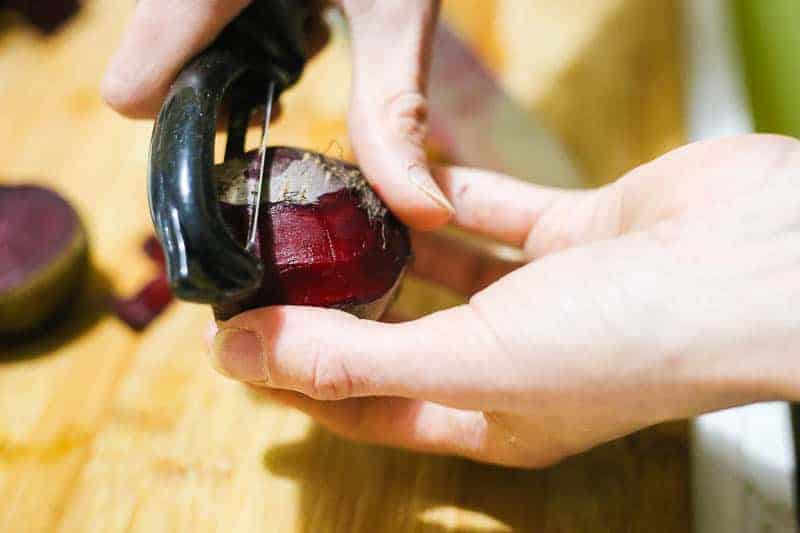 using a vegetable slicer to cut beet