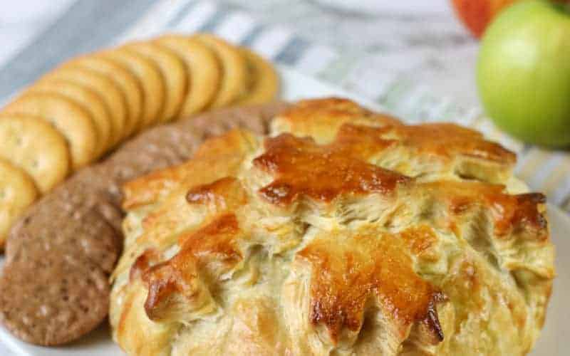 baked brie in puff pastry on plate with crackers