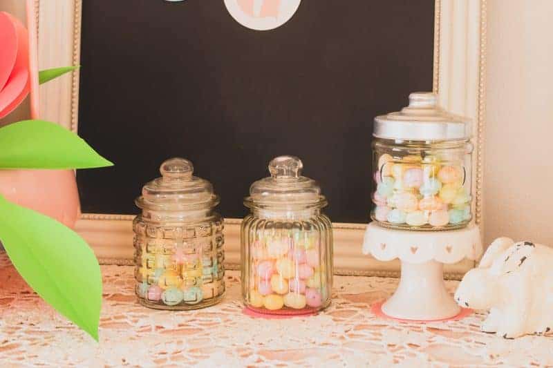 Three apothecary jars from the dollar tree filled with pastel candy