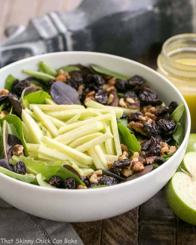Apple, Cherry, Walnut Salad with Maple Dressing - A fabulous fall/winter salad that always gets rave reviews! Apple, Cherry, Walnut Salad with Maple Dressing in a white serving bowl