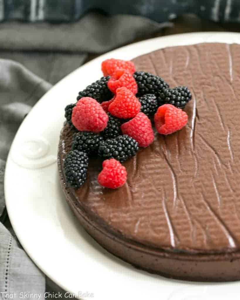 Flourless Cake Chocolate from Princeville Hotel - 5 simple ingredients make for one decadent, outrageously delicious dessert! Flourless Cake Chocolate from Princeville Hotel on a white serving plate