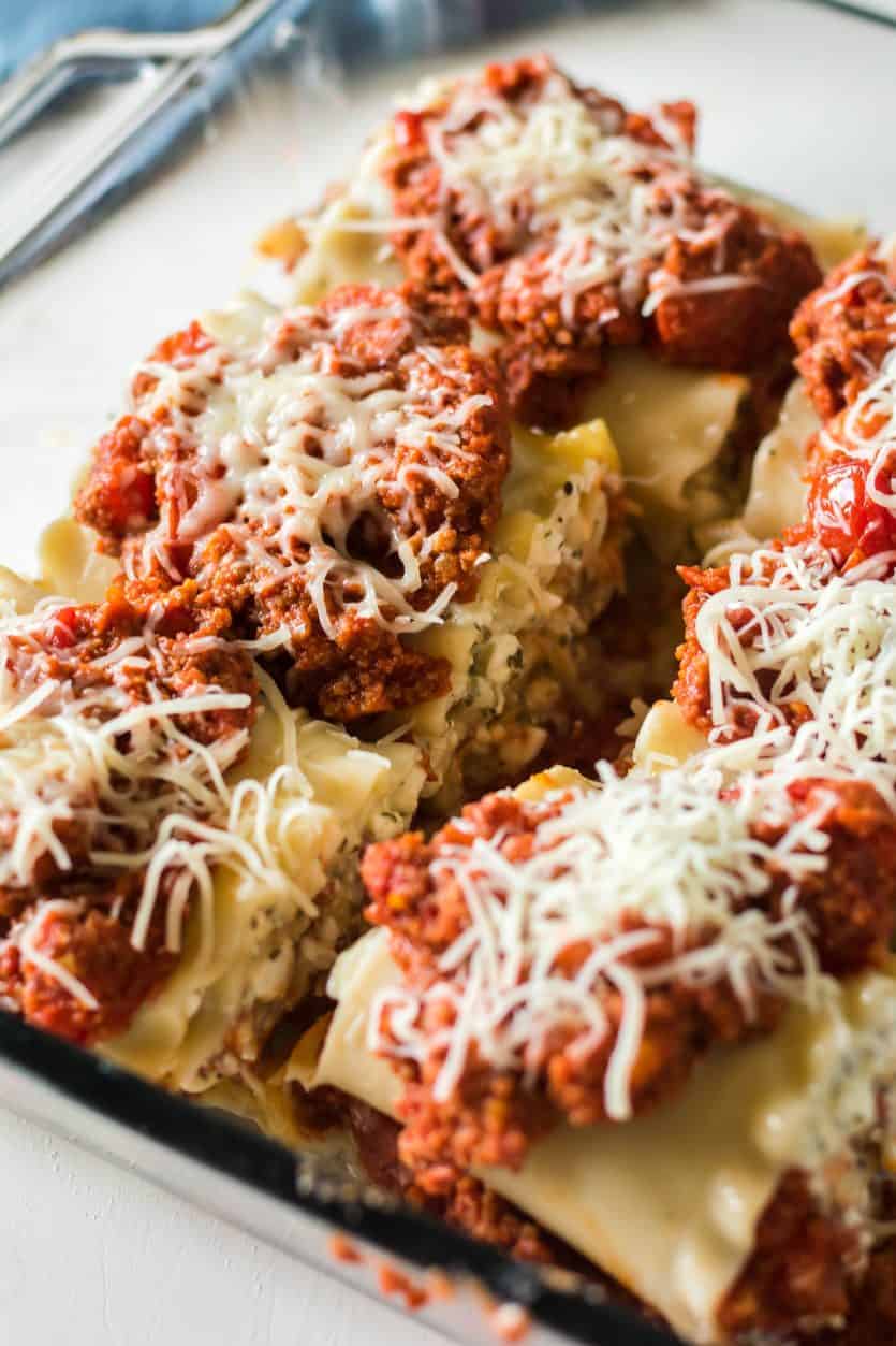 lasagna rolls topped with beef and pepperoni mixture ready to go into the oven