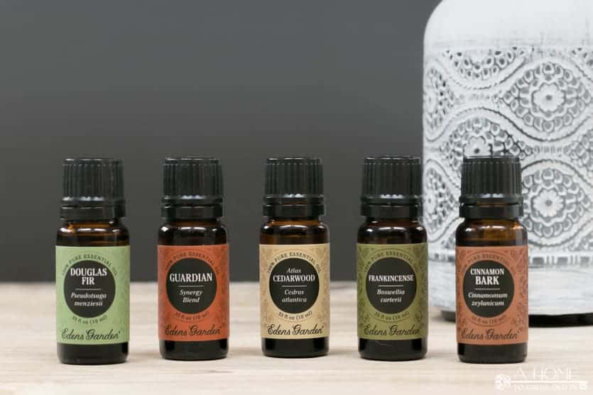 essential oil bottles in front of an oil diffuser