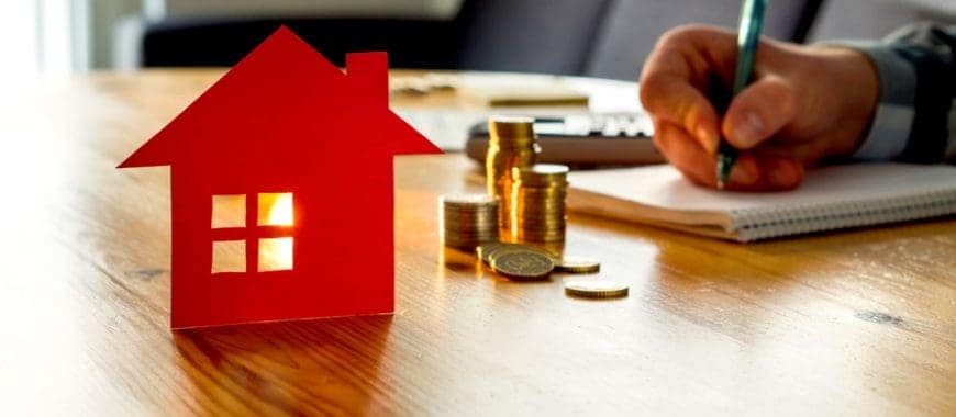 man counting money next house